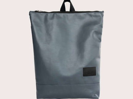 Grey faux leather backpack with zip closure and top handle, ideal for office or casual outings.