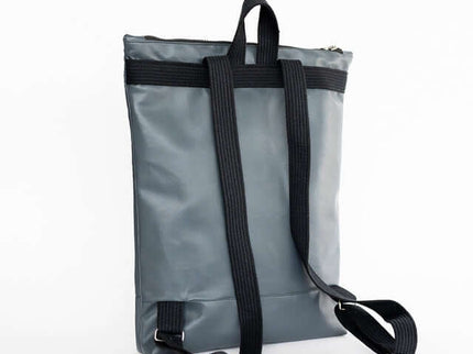 Grey faux leather backpack with adjustable straps and zipper closure, ideal for daily use and laptop storage.
