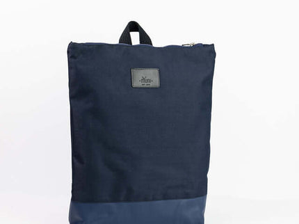 Waterproof backpack in navy blue with a leather bottom, perfect for work or outdoor use.