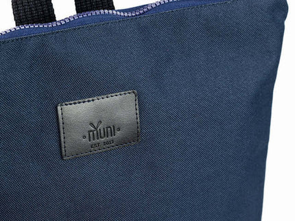 Close-up of a waterproof backpack featuring a blue leather bottom and logo, perfect for stylish daily use.