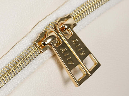 Close-up of a gold zipper on a cappuccino diaper backpack, showcasing quality craftsmanship.