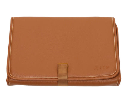 Brown leather changing mat with a sleek design, perfect for stylish parents on the go.