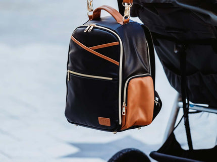 Small Diaper Backpack in Black Coffee, stylishly attached to a stroller for parents on the go.