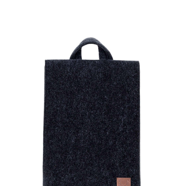 Stylish black backpack with minimalist design and handle, perfect for carrying laptops and essentials.