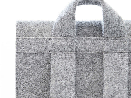 Close-up of the grey felt straps and handle of the stylish and practical Lund backpack.