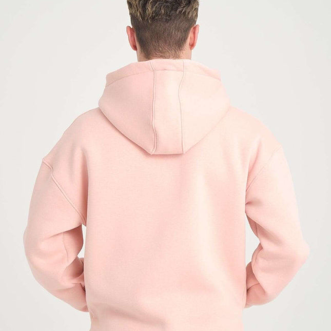 Back view of a man wearing a basic heavyweight pink zipper hoodie, showcasing the oversized fit and DALER embroidery.