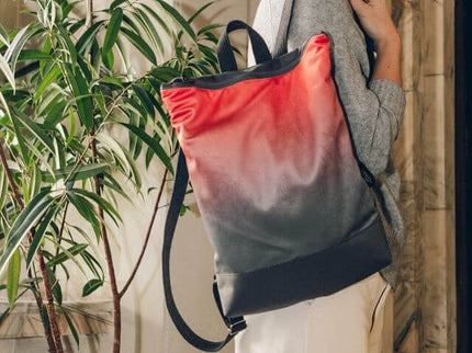 Stylish salmon faux leather backpack with adjustable straps, perfect for daily use.