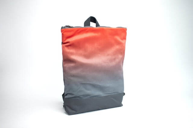 Faux leather salmon and gray gradient backpack perfect for daily use and stylish carry.