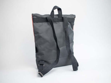 Faux leather backpack in salmon color with adjustable straps and a sleek design for daily use.