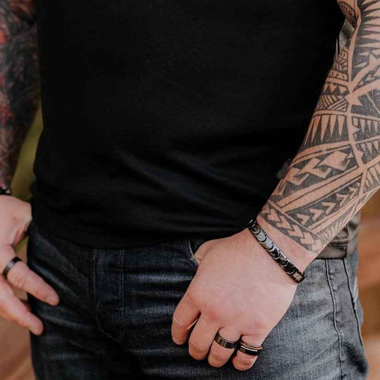 Gent black ceramic bracelet worn on a tattooed wrist