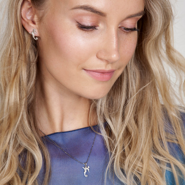Model wearing silver Mini Hippocamp earring with matching necklace