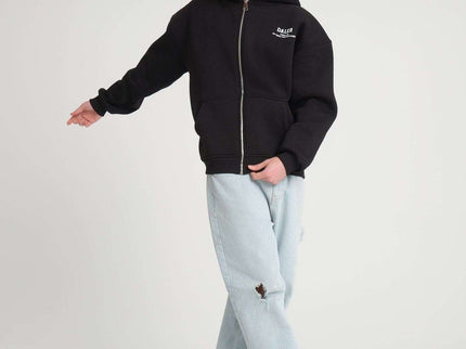 Heavyweight zipper hoodie in black, oversized fit, worn by male model, showcasing front design.