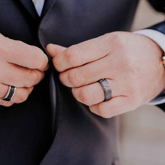Tau black ceramic ring worn with a dark suit