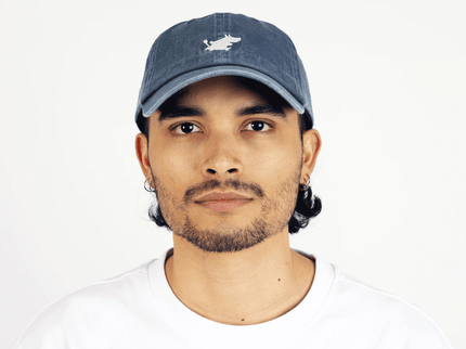 Moomintroll washed denim cap in blue worn by a young adult male with a casual style.