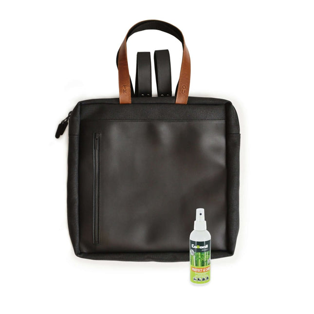 Stockholm Backpack in black with leather straps and a bottle of protectant spray for maintenance.