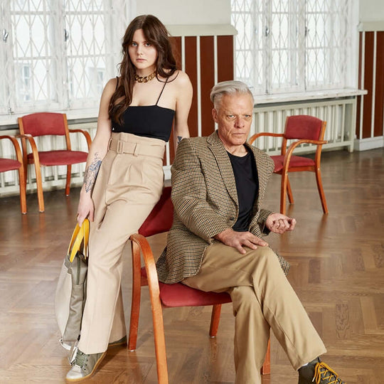 Models wearing TOKU Stockholm light grey high-top sneakers indoors
