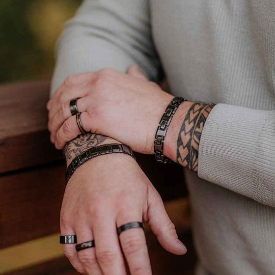 Trey black ceramic bracelet worn while holding a dog