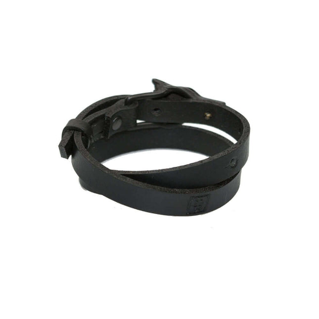 Double wrap black matte leather bracelet with wolf buckle, symbolizing strength and individuality.